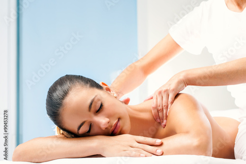 Young woman having spa back massage.