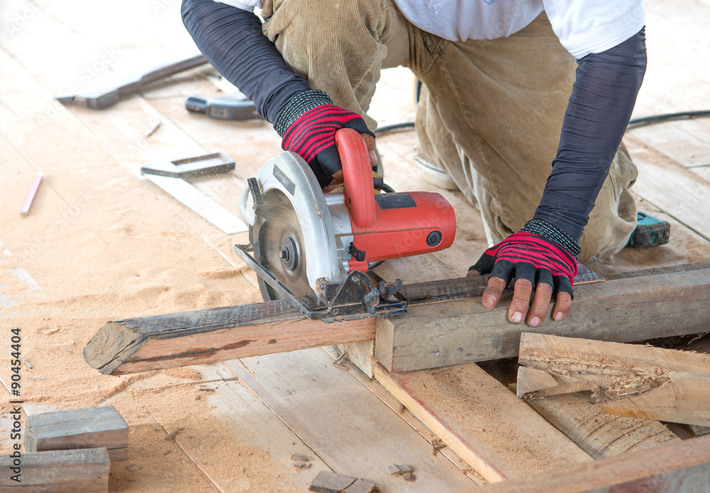 Man carpenter cutting wood with electric saw, for Home Building Man carpenter cutting wood with electric saw, for Home Building