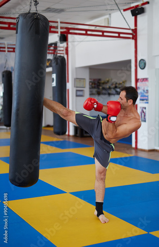 Kickbox fighter training with the punch bag
