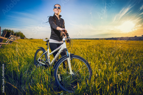 Fototapeta Naklejka Na Ścianę i Meble -  Woman is riding bicycle outside