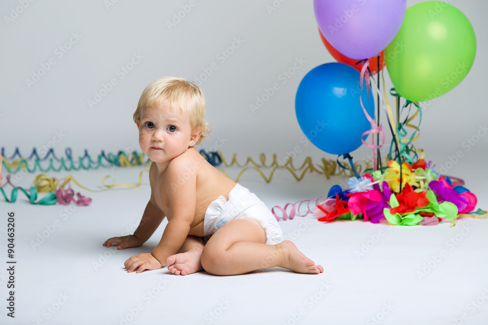 Baby girl celebrating her first bithday with gourmet cake and ba Baby girl celebrating her first bithday with gourmet cake and ba