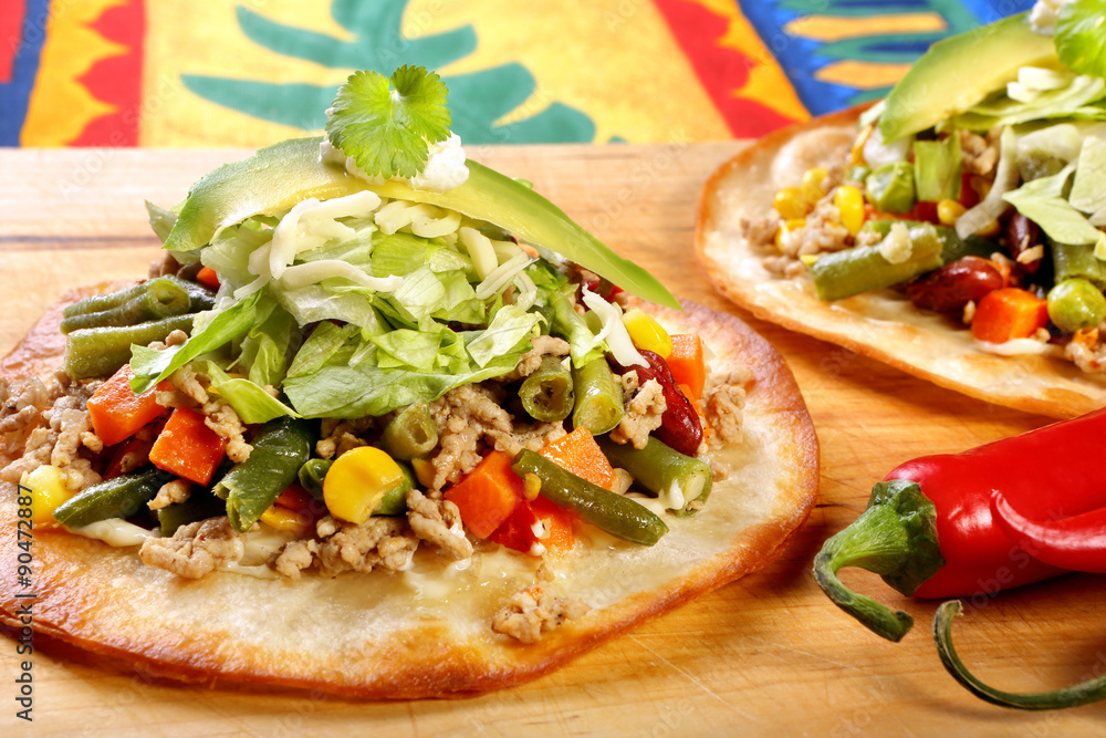 Tostadas with ground beef and vegetables on wooden background Tostadas with ground beef and vegetables on wooden background
