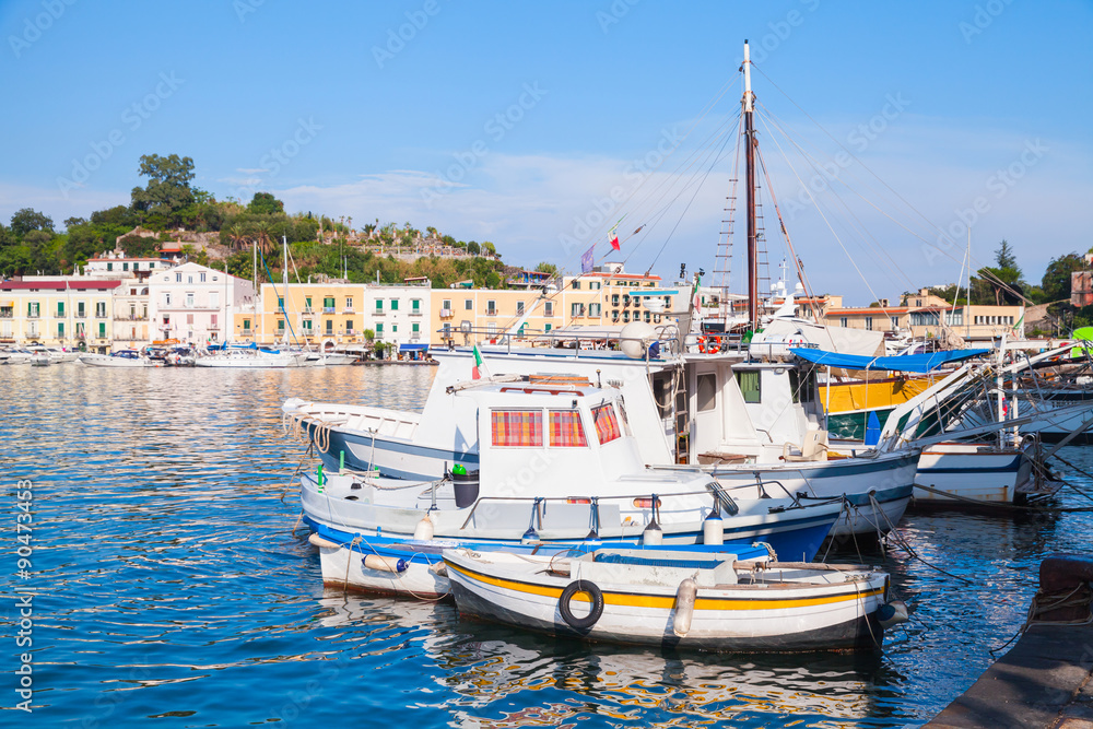 Small fishing boats in old Ischia port, Italy