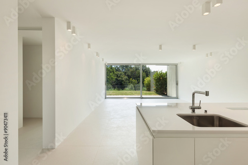 Domestic kitchen of a modern house. Empty space and view on the garden