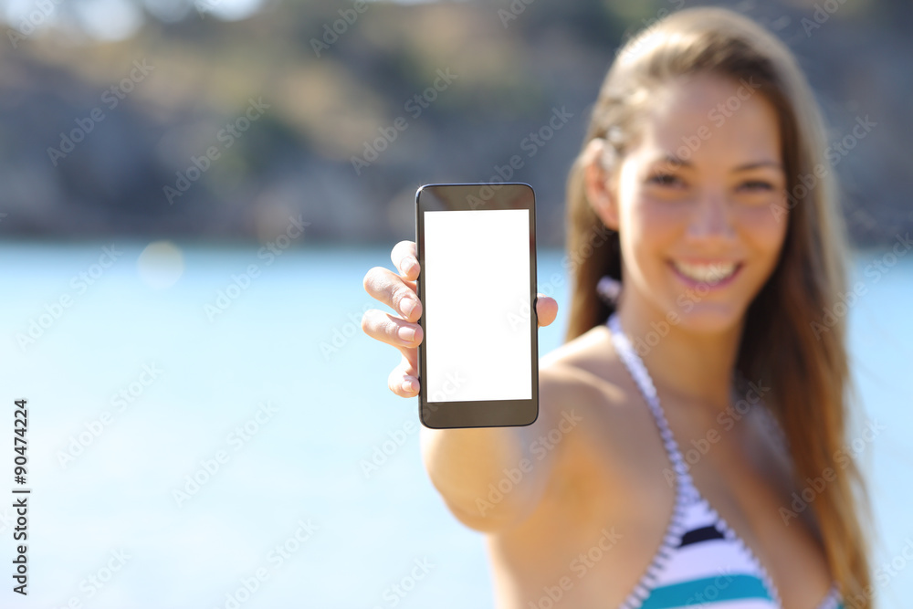 Sunbather showing blank phone screen on the beach