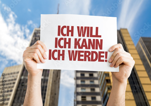 I Want I Can I Will (in German) placard with cityscape background