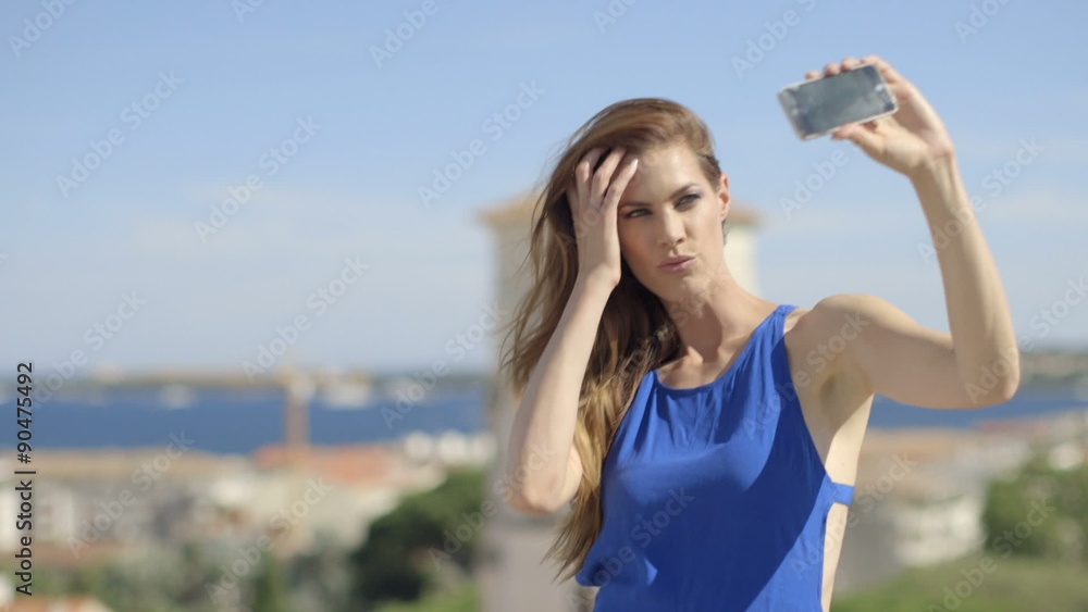 Woman self photographing in balcony Woman self photographing in balcony