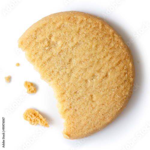 Single round shortbread biscuit with crumbs and bite missing. Fr photo