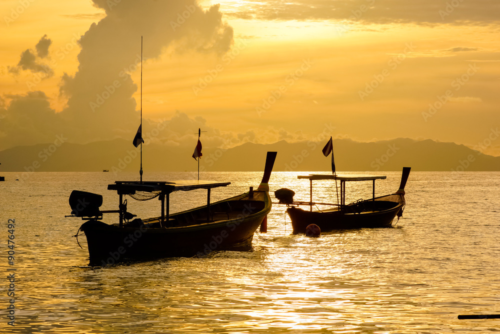 Fishing boat floating on the sea at dawn.