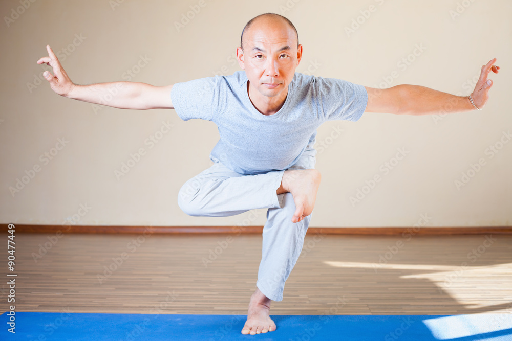Fototapeta premium Inspired asian man doing exercise of yoga indoor