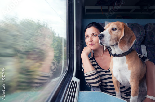 Woman travel with dog into the train wagon