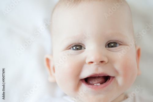 Fotografie Happy cute laughing baby. Positive smiling  child. Smiling kid.