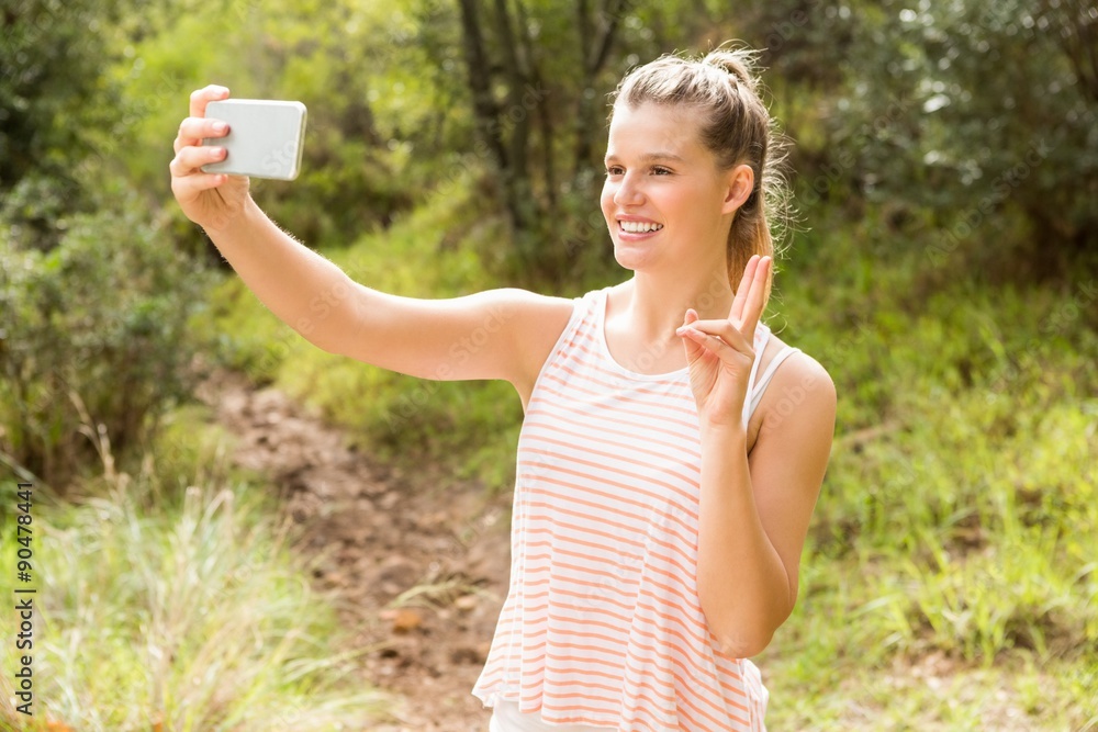 Pretty blonde showing peace sign and taking selfies Pretty blonde showing peace sign and taking selfies