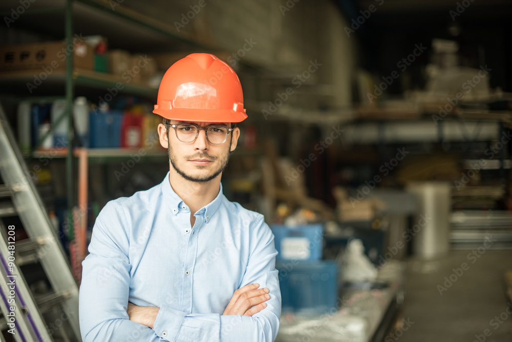a young man with a helmet on his head on an industrial site a young man with a helmet on his head on an industrial site