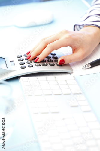 Businesswoman using calculator