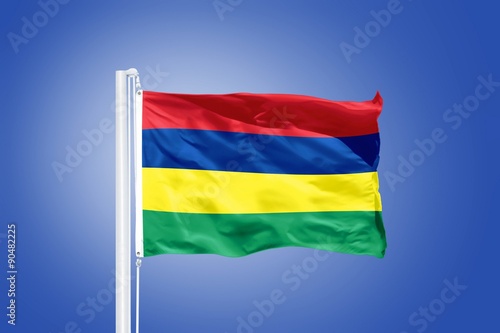 Flag of Mauritius flying against a blue sky