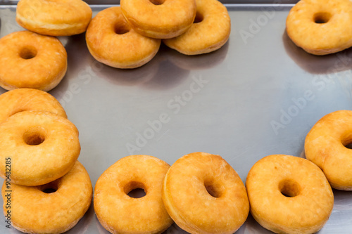 fried equal round doughnuts in frame © sytnik