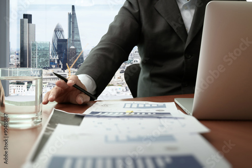 Photography business documents on office table with smart phone and digital