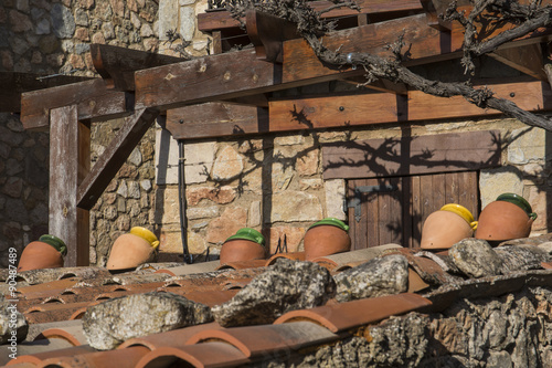 Roof of a house, decorated with vases in different colors photo