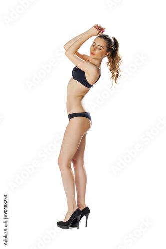 Full length portrait of a beautiful young model in black bikini