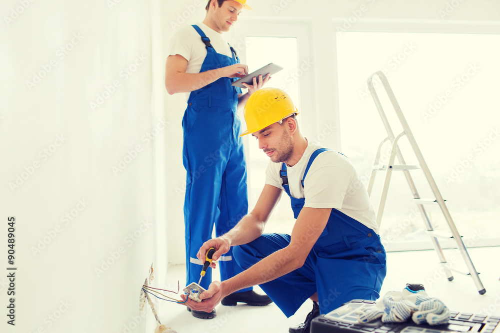 builders with tablet pc and equipment indoors builders with tablet pc and equipment indoors