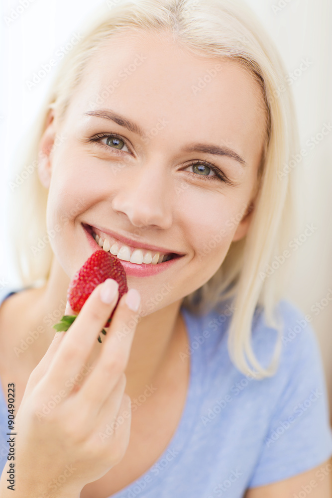 happy woman eating strawberry at home happy woman eating strawberry at home