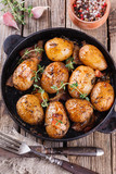 Young potatoes fried in a pan. With garlic, pancetta and thyme.selective focus