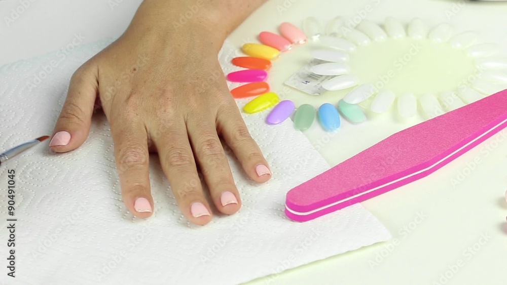 Manicure in process - decoration design by silver glitter on pink color gel female nails
Manicure in process - decoration design by silver glitter on pink color gel female nails
