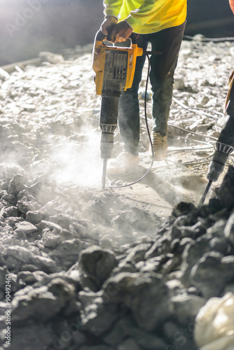Tablou pe pânză Road repairing works with jackhammer at night
