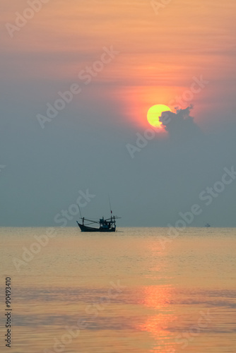 Fishing boat floating on the sea at dawn.