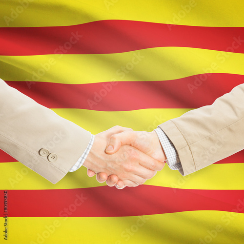 Businessmen handshake with flag on background - Catalonia - Spai