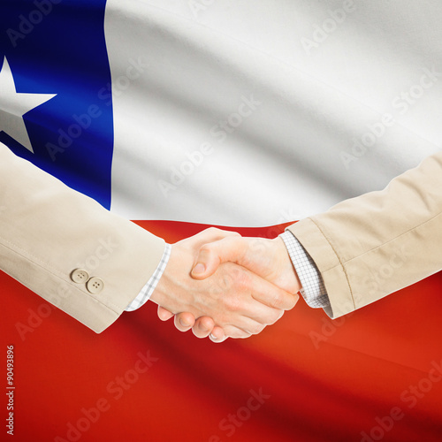 Businessmen handshake with flag on background - Chile