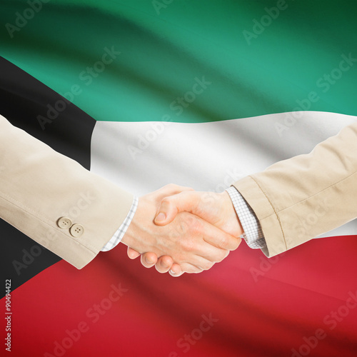 Businessmen handshake with flag on background - Kuwait