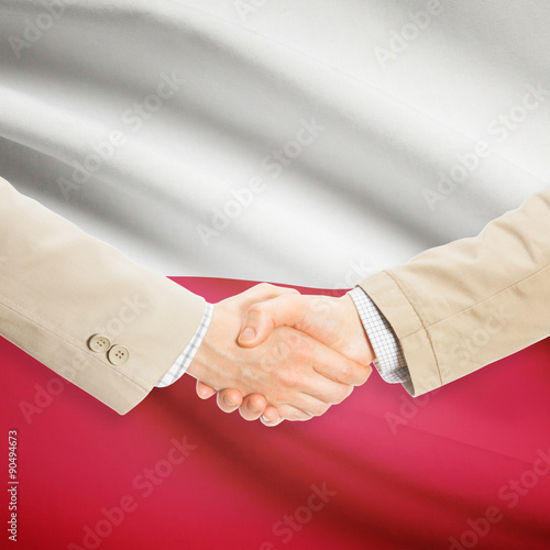 Businessmen handshake with flag on background - Poland