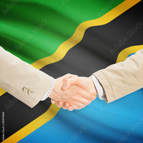 Businessmen handshake with flag on background - Tanzania