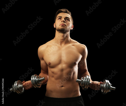 Muscle young man holding du...
