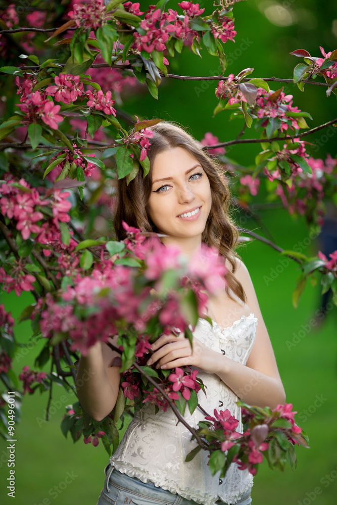 Young spring fashion woman in spring garden Springtime Summertim Young spring fashion woman in spring garden Springtime Summertim