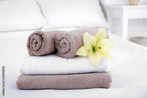 Freshly laundered fluffy towels in bedroom interior