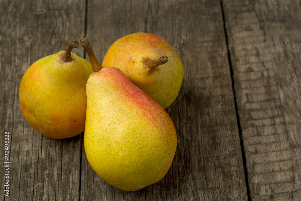 fresh ripe organic pears on a rustic wooden table fresh ripe organic pears on a rustic wooden table