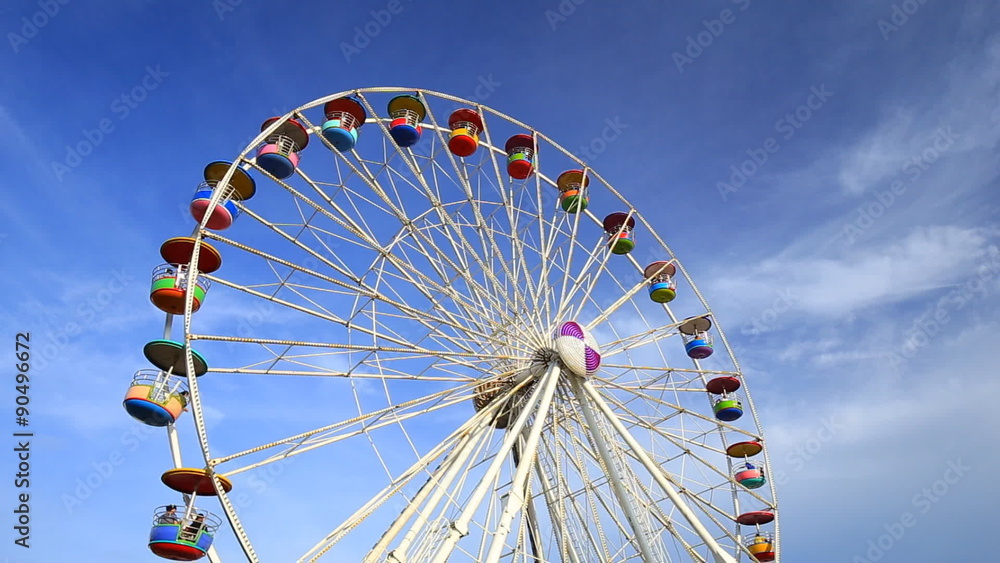 Ferris Wheel at amusement park with blue sky background Ferris Wheel at amusement park with blue sky background