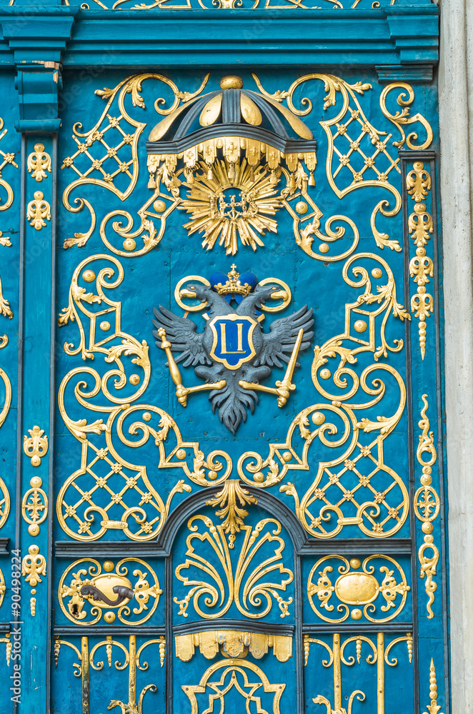 Blue door decorated with golden adornment Blue door decorated with golden adornment