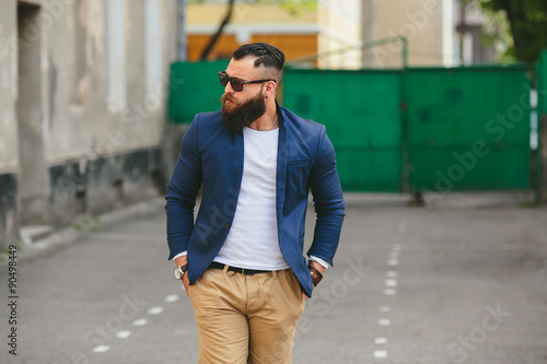Stylish bearded man walks through the city