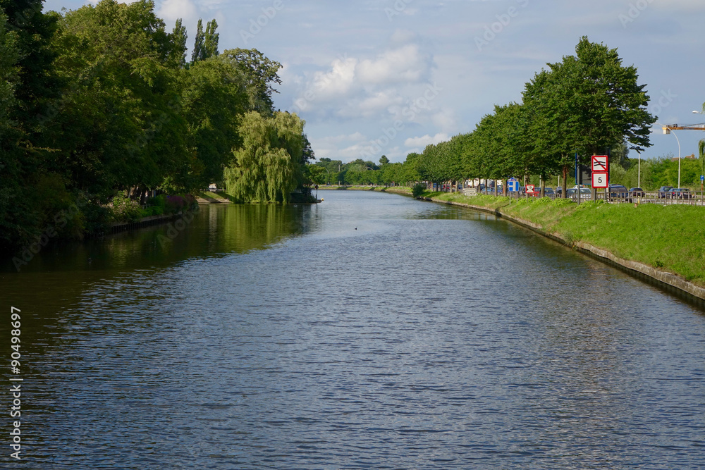 blue river with green trees at the side