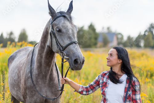 Young woman with a horse