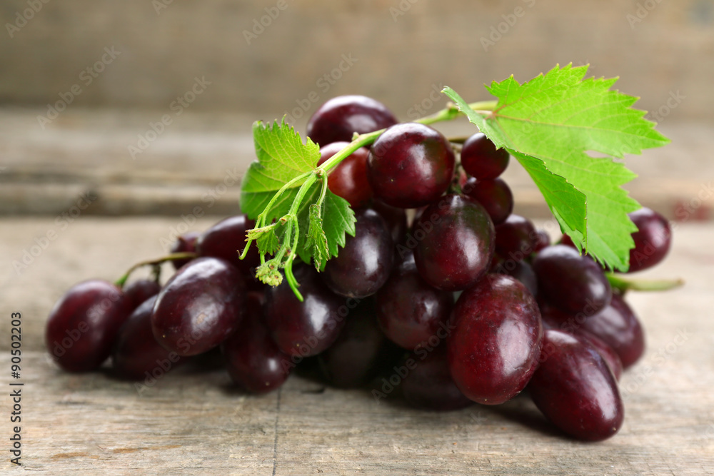 Fresh ripe grapes on old wooden table Fresh ripe grapes on old wooden table