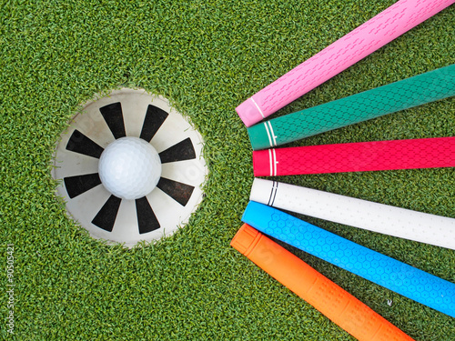 Canvas Print Colorful golf grips point to the hole with ball