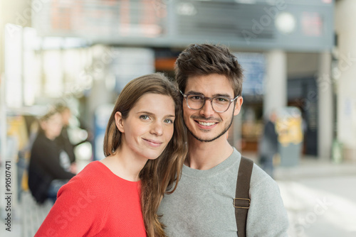  a young couple about to take the train at the station