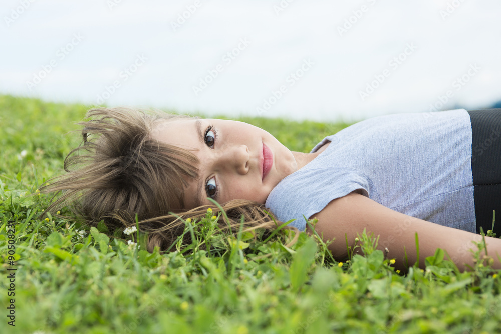 Beautiful portrait of a little girl outside on grass Beautiful portrait of a little girl outside on grass