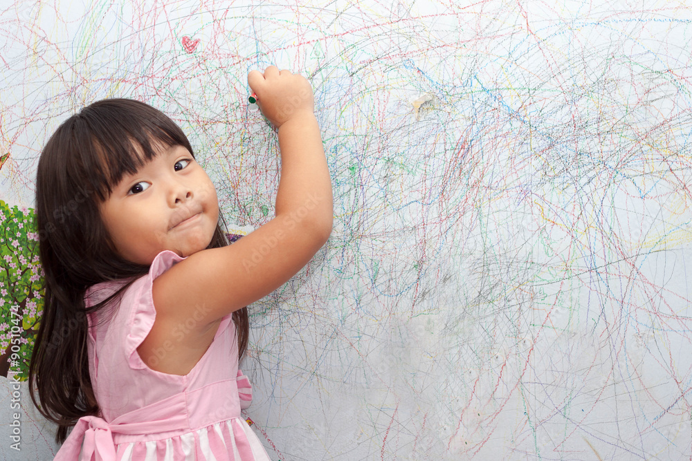 girl drawing with crayons on the wallpaper girl drawing with crayons on the wallpaper
