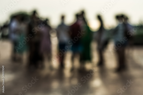 Blurred group of people during sunset